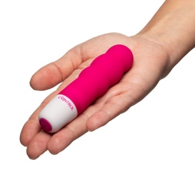 Vibrador pequeno rosa com base branca e palavra 'CONTROL'