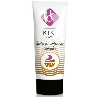 Embalagem tubular branca com tampa preta de produto KIKI TRAVEL com padrão dourado e ícone de cupcake roxo
