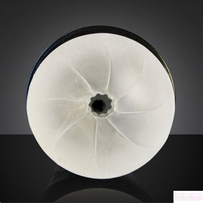 Objeto circular branco translúcido com abertura central e base preta em fundo cinzento