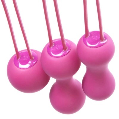 Três bolas de treino rosa com hastes, em fundo branco