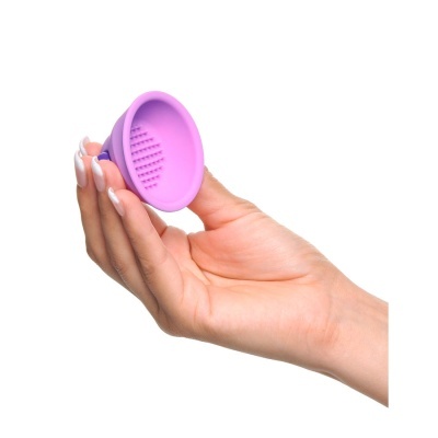 Acessório pequeno de silicone roxo com textura segurado por mão feminina