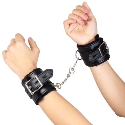 Algemas de couro preto com corrente metálica nos pulsos