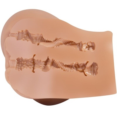 Molde de silicone cor de pele com cavidades internas texturizadas.