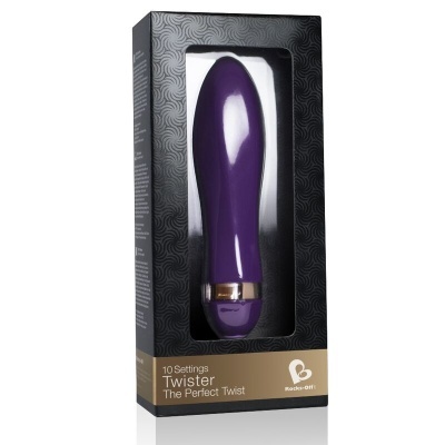 Vibrador roxo em caixa preta com detalhes dourados e janela transparente