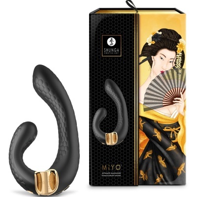 Massageador preto com detalhes dourados e embalagem com ilustração japonesa
