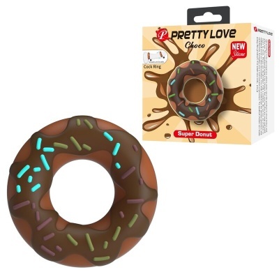 Anel em silicone castanho com cobertura que simula chocolate e granulados, e embalagem do produto.