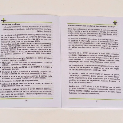 Livro aberto com texto em português sobre emoções positivas nas páginas 10 e 11.