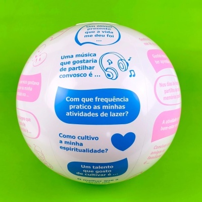 Bola branca com textos em azul e rosa sobre fundo verde