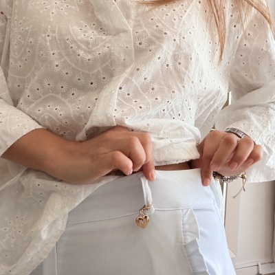 Blusa branca bordada com calças brancas e detalhe de coração no cinto