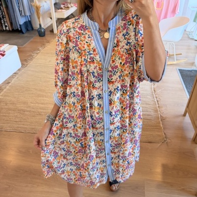 Vestido floral colorido com gola e fecho de botões riscado em loja