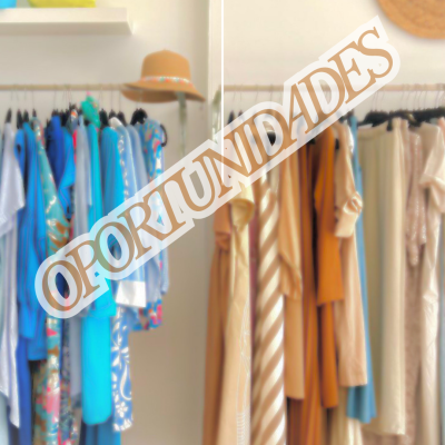 Roupas coloridas em araras, chapéu na parede e malas na prateleira