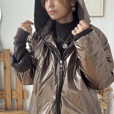 Mulher a usar casaco metálico castanho com capuz e fecho de correr