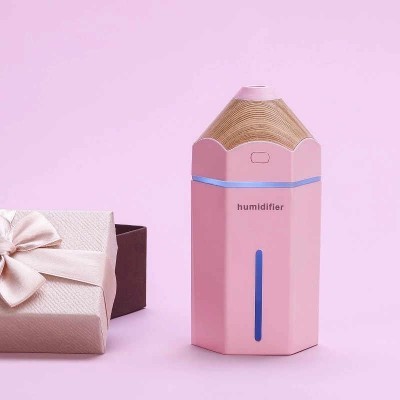 Humidificador rosa com topo em madeira e caixa de presente ao lado