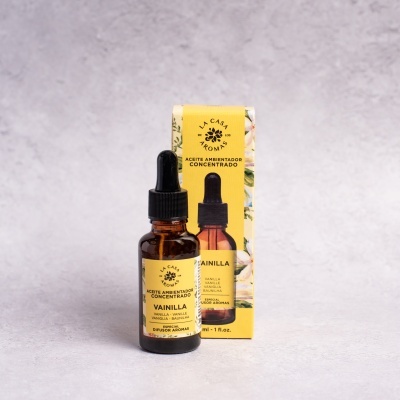 Frasco âmbar com óleo aromatizante e caixa amarela de baunilha