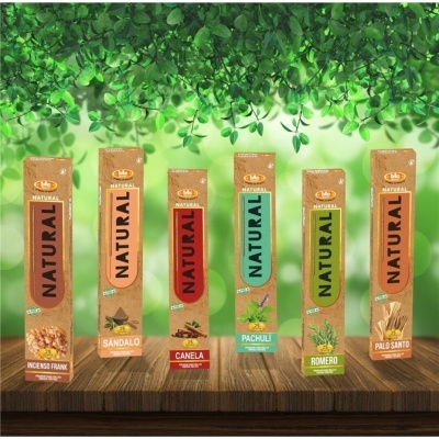 Seis caixas coloridas de incenso Natural em madeira com fundo de folhas verdes