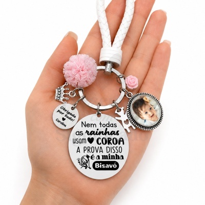 Chaveiro com pendentes metálicos e foto de criança, texto em português, cordão branco trançado.