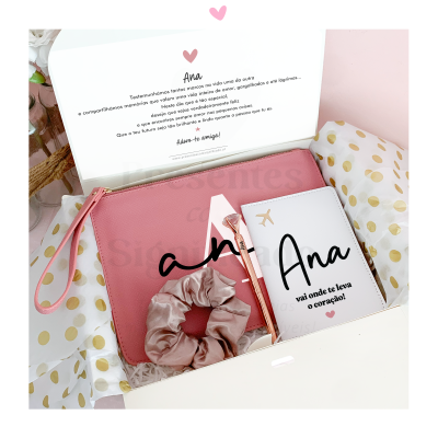 Conjunto de presentes personalizados com bolsa rosa, carteira branca com texto, caneta rosa e elástico de cabelo em caixa branca com papel de seda com pontos dourados
