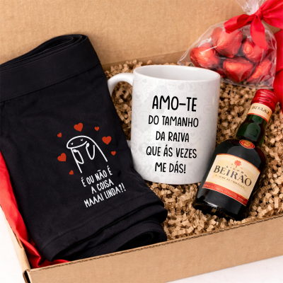 Caixa de presente com t-shirt preta, caneca com texto, licor Beirão e doces em saco com laço vermelho.