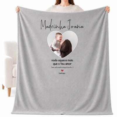 Manta cinzenta personalizada com texto e foto, segurada por pessoa com camisola clara