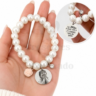 Pulseira perolada branca com pendentes decorativos e texto em português