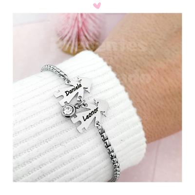 Pulseira com peças de puzzle personalizadas e pedra brilhante num pulso com camisola branca