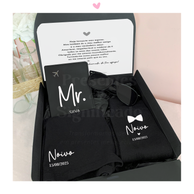 Caixa preta aberta com carteira, óculos escuros e roupa preta com textos personalizáveis para noivo