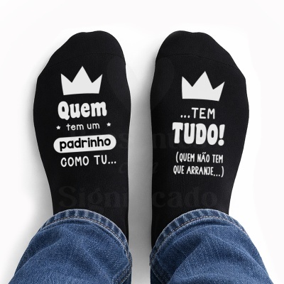 Meias pretas com texto branco sobre padrinho e coroa, calças de ganga visíveis