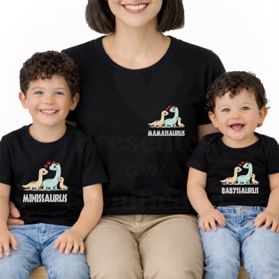 Família vestindo t-shirts pretas com ilustrações e textos MAMASAURUS, MINISAURUS e BABYSAURUS.