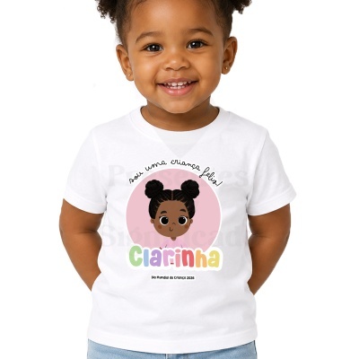 Camisola branca para criança com desenho e texto colorido no centro.