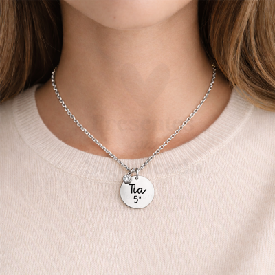 Colar prateado com pendente redondo gravado com Tia 5* e pedra brilhante