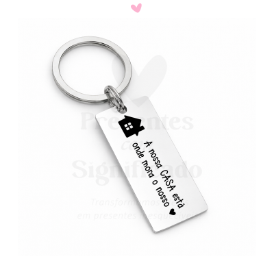 Porta-chaves metálico com pendente retangular gravado com casa preta e frase em português.