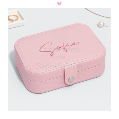 Caixa de joias rosa com fecho prateado e acessórios ao redor