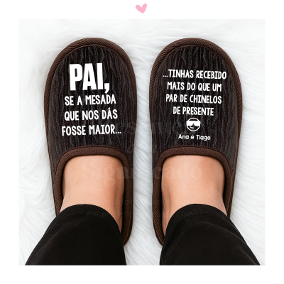 Par de chinelos castanhos com texto branco sobre fundo branco felpudo