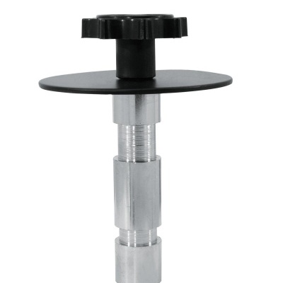 Peça metálica com disco e botão preto