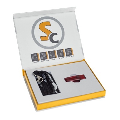 Kit com dispositivo preto e peça vermelha em caixa branca e amarela com texto PRLTS