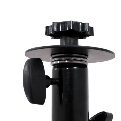 Componente preto metálico e plástico com botões de aperto e disco circular