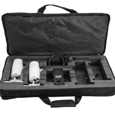 Mala preta aberta com dois dispositivos brancos cilíndricos e um dispositivo eletrónico negro dentro