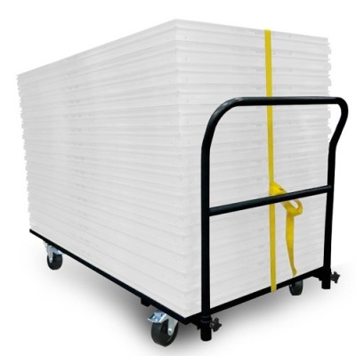 Carrinho metálico preto com rodas, carregando placas brancas empilhadas e presas com cinta amarela