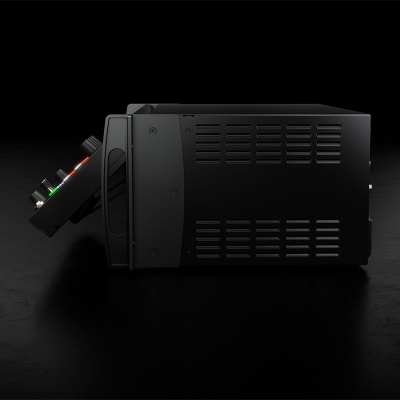 Aparelho eletrónico preto com botões coloridos e ventilações laterais