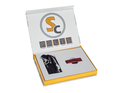 Kit com dispositivo preto e peça vermelha em caixa branca e amarela com texto PRLTS