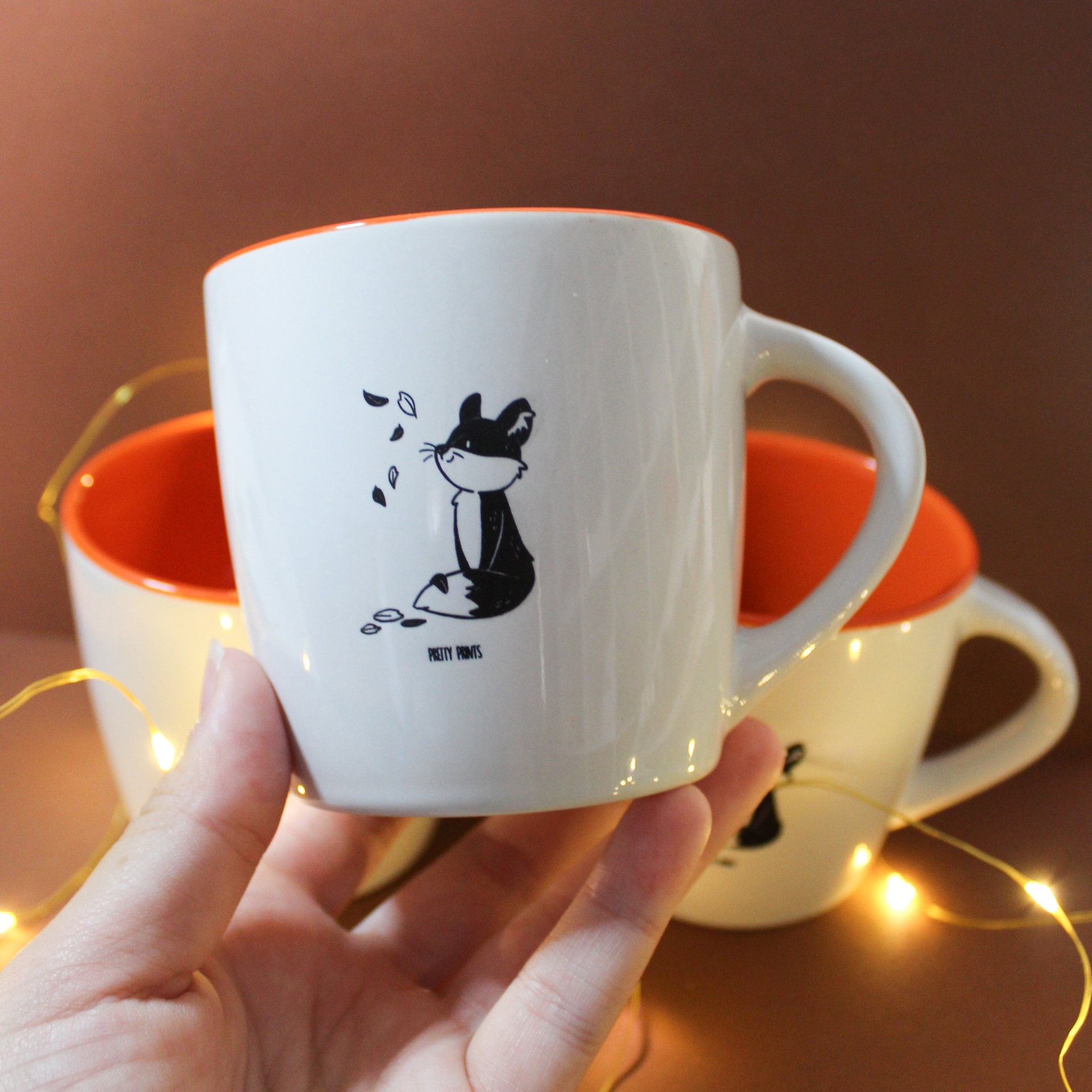 Conjunto de canecas brancas com interior laranja e estampa de raposa preta