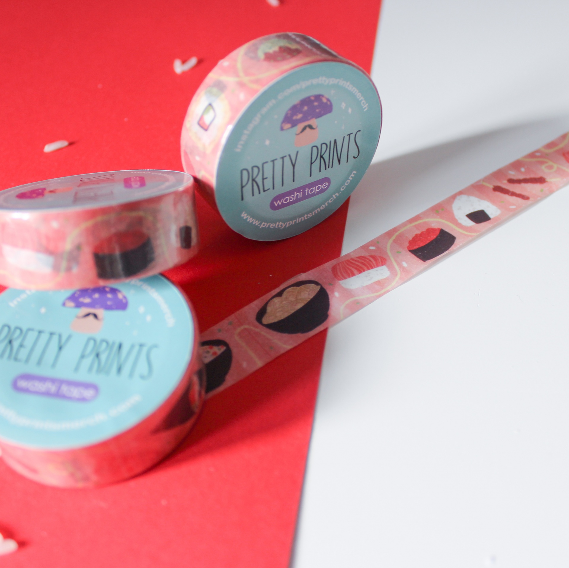 Rolos de fitas washi tape decorativas com padrão de sushi e rótulos azuis