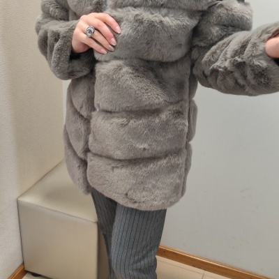 Casaco de pêlo cinzento claro com calças cinzentas e botas pretas