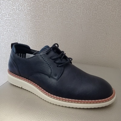 Sapato masculino preto com sola branca e detalhe castanho em fundo claro