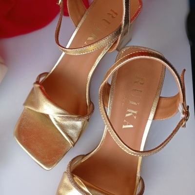 Sandálias douradas com tiras cruzadas e fecho de fivela