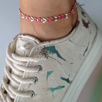 Tornozeleira rosa e dourada com ténis branco texturado e cordões brancos