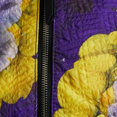 Tecido floral roxo e amarelo com fecho de correr preto