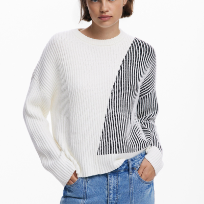 Camisola de malha branca com riscas pretas e calças jeans azuis.