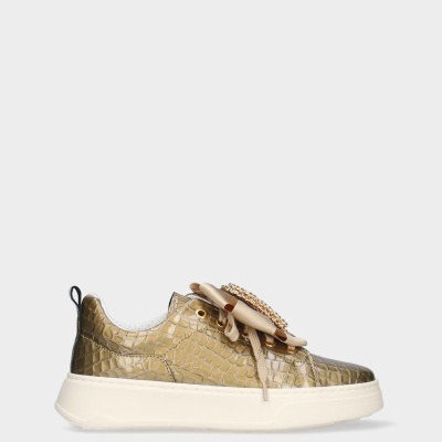 Ténis dourado com padrão crocodilo e laço decorativo