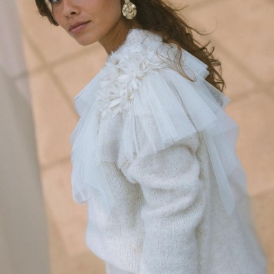 Blusa branca de malha com tule e flores decorativas no ombro